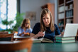 © sepy - A visually impaired young woman sitting and studying in the university library
