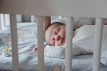 Baby Girl Sleeping In Crib At Home