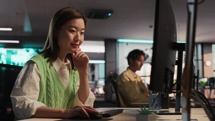 Fototapete - Female Talented Digital Marketing Specialist Working on Computer in The Modern Office. Young And Successful Asian Businesswoman in Creative Agency, Smiling and Researching Business Analytical Data.