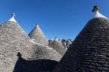 Wall Mural - Roofs of Trulli of Alberobello, the typical limestone houses in the province of Bari, Puglia, Italy