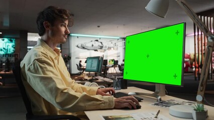 Aufkleber - Portrait of Creative Caucasian Man Sitting at a Desk Using Desktop Computer with Mock-up Green Screen Chromakey. Male Level Designer Working in Game Design Startup Office, Creating Immersive Gameplay.