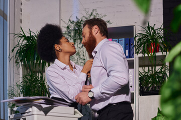 young african american secretary undressing bearded businessman near copier, romance in office