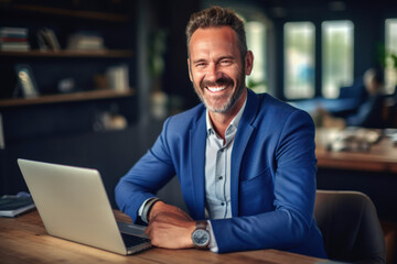 Happy smiling middle aged professional business man company executive ceo manager wearing blue suit sitting at desk in office working on laptop computer laughing at workplace. Portrait. AI Generative