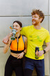 © Drobot Dean - Smiling couple drinking water after workout outdoors