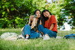 © Drobot Dean - Two asian women taking selfie while sitting in green park