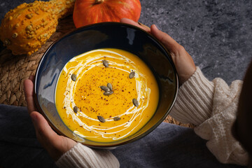 Wall Mural - Crop woman with bowl of pumpkin soup