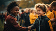 Two children handshaking to each other for joining agreement to compete the sport with crowd background.
