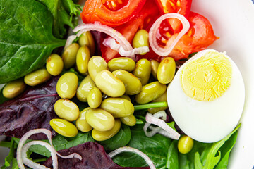 edamame bean salad vegetables, tomato, boiled egg appetizer meal food snack on the table copy space food background rustic top view