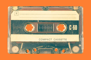 Wall Mural - vintage old audio compact cassette in front of an orange background
