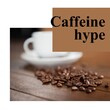 Caffeine hype text on brown with coffee beans and white cup on wooden table