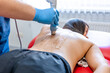 © puhimec - Extracorporeal shockwave therapy, physical therapy for neck and back muscles.