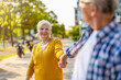 © pikselstock - Portrait of happy senior couple standing in city street on a sunny day