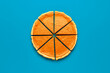 Sliced pumpkin pie top view, minimalist on a blue table