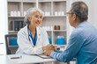 © Phushutter - Asian people mature dentist having a compassionate conversation with elderly patient, discussing oral health results, providing expert advice and detailed dental report. Dental Guidance