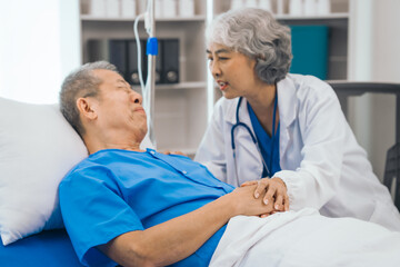 Wall Mural - Senior elderly male patient and asian people mature woman doctor, showcasing importance of healthcare expertise and patient support. caring senior doctor assisting elderly patient in hospital bed