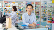 © NVB Stocker - Pharmacy Drugstore. Portrait Professional Pharmacist handsome asian man showing the medicine bottle at pharma store. Health and wellness center