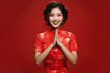 Happy Chinese New Year , Asian woman wearing traditional cheongsam qipao dress on red background