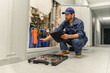 © Daria - Male plumber diagnoses pipes in water supply system before repairing and makes notes in clipboard