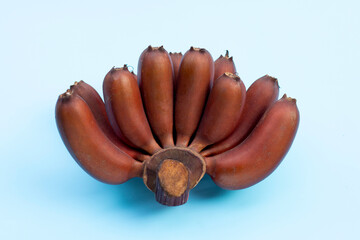 Wall Mural - Red banana on blue background.