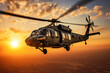 seahawk (or blackhawk) helicopter flies low against a setting sun in the middle east
