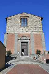 Canvas Print - The facade of an old church in the medieval quarter of Lucignano, a village in Tuscany.