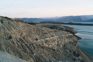 Rocky mountain cliff near sea during daytime