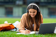 © Prostock-studio - Smart young woman student chilling at park, attending webinar