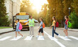 © Prostock-studio - Group of children passing crosswalk on their way to school bus