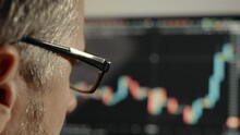 Man In Glasses Studying Cryptocurrency Chart, Stock Market Analysis, Trading Online, Trader At Workplace