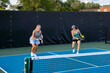 © pics721 - Two Female Pickleball Players at the Baseline