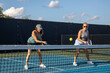 © pics721 - Two Female Pickleball Players at the Net