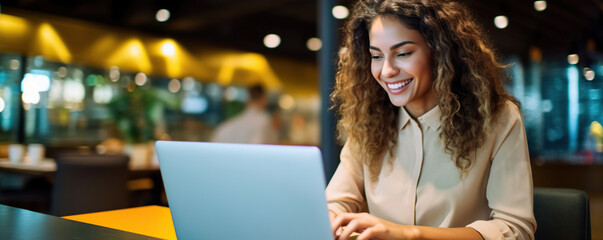 Wall Mural - Professional female employee or a businesswoman using a laptop in a public place. Copy space