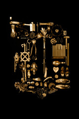 the letter d made with gold objects on a flat surface on black background