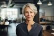 © Geber86 - Smiling portrait of a senior caucasian woman working in a modern business office