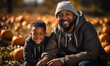 Father and son sitting in pumpkin patch, outdoors portrait. Happy family at farm picking pumpkins for Halloween or Thanksgiving Day.