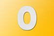 White paper font number 0 isolated on yellow background.
