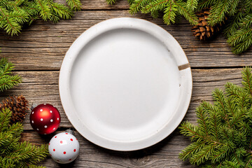 Wall Mural - Table setting from above with empty plate, Christmas Fir tree