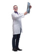 © ASDF - Attractive doctor examining an x-ray and looking at the camera