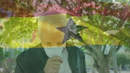 Poster - Animation of waving ghana flag against caucasian man wearing face mask coughing on the street