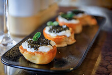 Mini Brioche Toast With Creme Fraiche And Black Sturgeon Caviar With A Colorful Interior At A Luxury Restaurant, The Carre DíOr, Nice, South Of France