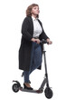 © ASDF - in full growth. confident adult woman with an electric scooter