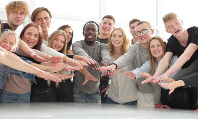 Wall Mural - multinational group of young people joining their palms