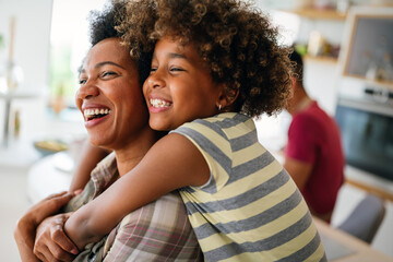 Wall Mural - African american woman hugging her smiling teen daughter. Family love single parent child concept