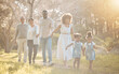 © Anela/peopleimages.com - Big family in park, holding hands and walking together for love, bonding on nature adventure. Mother, father and children in garden with grandparents, parents and kids on path in woods or forrest.