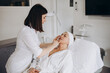 © Roman - The doctor cosmetologist makes the rejuvenating facial injections procedure for tightening and smoothing wrinkles on the face skin of a beautiful, young woman in a beauty salon. Cosmetology, skincare