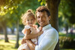 © JKLoma - Portrait of a happy father and his little daughter in the park
