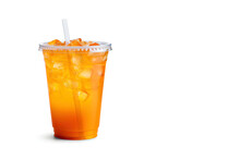 Orange color drink in a plastic cup isolated on a white background. Take away drinks concept with copy space