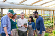 © Robert Kneschke - Smiling multiracial farmers discussing over tablet PC at farm