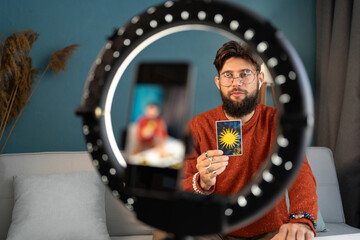 fortune teller blogger with ring light and tarot cards to prediction future. astrologist blogger rea