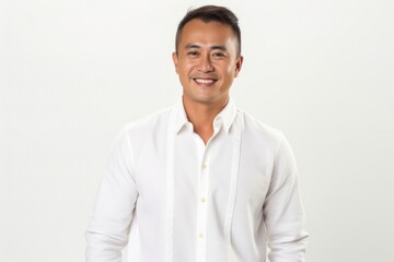 portrait of a confident Filipino man in his 40s wearing a chic cardigan against a white background